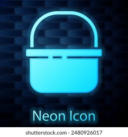 Glowing neon Basket icon isolated on brick wall background. Online buying concept. Delivery service sign. Shopping cart symbol.  Vector