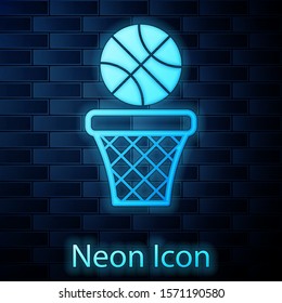 Glowing neon Basketball ball and basket icon isolated on brick wall background. Ball in basketball hoop.  Vector Illustration