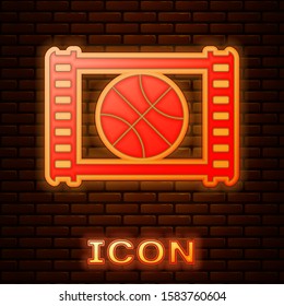 Glowing neon Basketball game video icon isolated on brick wall background.  Vector Illustration