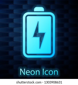 Glowing neon Battery icon isolated on brick wall background. Lightning bolt symbol. Vector Illustration