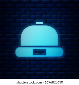 Glowing neon Beanie hat icon isolated on brick wall background.  Vector Illustration
