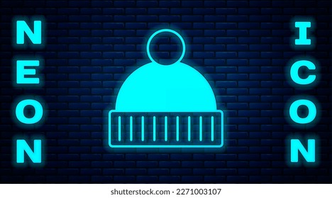 Glowing neon Beanie hat icon isolated on brick wall background.  Vector