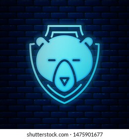 Glowing neon Bear head on shield icon isolated on brick wall background. Hunting trophy on wall.  Vector Illustration