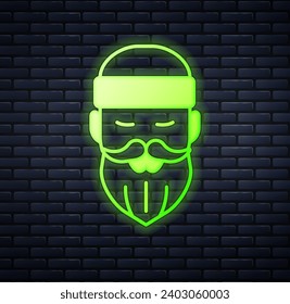 Glowing neon Bearded lumberjack man icon isolated on brick wall background.  Vector