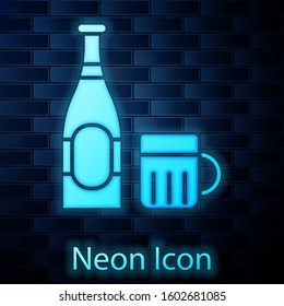 Glowing neon Beer bottle and glass icon isolated on brick wall background. Alcohol Drink symbol.  Vector Illustration