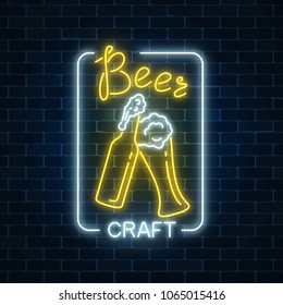 Glowing neon beer craft signboard in rectangle frame on dark brick wall background. Luminous advertising sign