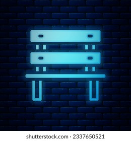 Glowing neon Bench icon isolated on brick wall background.  Vector