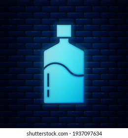 Glowing neon Big bottle with clean water icon isolated on brick wall background. Plastic container for the cooler.  Vector