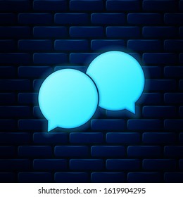Glowing neon Blank speech bubbles icon isolated on brick wall background.  Vector Illustration