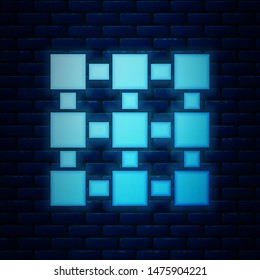 Glowing neon Blockchain technology icon isolated on brick wall background. Cryptocurrency data. Abstract geometric block chain network technology business.  Vector Illustration