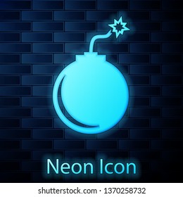 Glowing neon Bomb ready to explode icon isolated on brick wall background. Vector Illustration