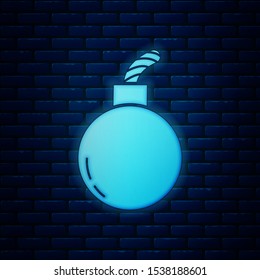 Glowing neon Bomb ready to explode icon isolated on brick wall background.  Vector Illustration