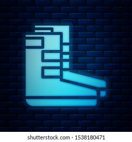 Glowing neon Boots icon isolated on brick wall background. Diving underwater equipment.  Vector Illustration