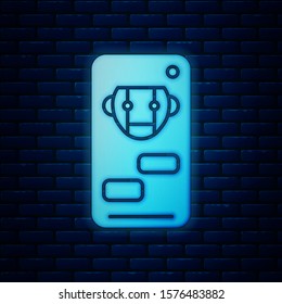 Glowing neon Bot icon isolated on brick wall background. Robot icon.  Vector Illustration