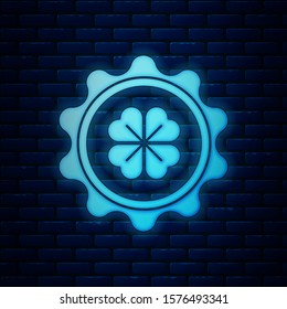 Glowing neon Bottle cap with four leaf clover icon isolated on brick wall background. Happy Saint Patricks day.  Vector Illustration