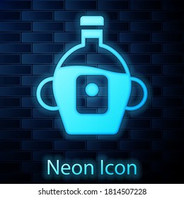 Glowing neon Bottle of maple syrup icon isolated on brick wall background. Vector.