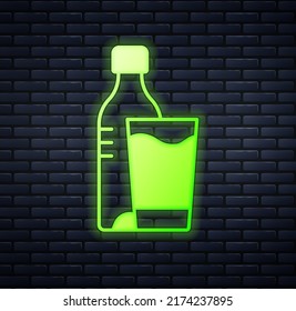 Glowing neon Bottle of water with glass icon isolated on brick wall background. Soda aqua drink sign.  Vector