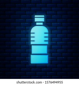 Glowing neon Bottle of water icon isolated on brick wall background. Soda aqua drink sign.  Vector Illustration