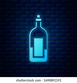 Glowing neon Bottle of wine icon isolated on brick wall background.  Vector Illustration