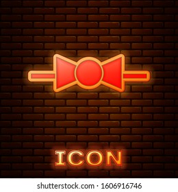 Glowing neon Bow tie icon isolated on brick wall background.  Vector Illustration