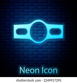 Glowing neon Boxing belt icon isolated on brick wall background. Belt boxing sport championship winner fight award.  Vector