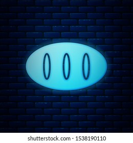 Glowing neon Bread loaf icon isolated on brick wall background.  Vector Illustration