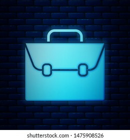 Glowing neon Briefcase icon isolated on brick wall background. Business case sign. Business portfolio.  Vector Illustration