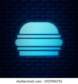 Glowing neon Burger icon isolated on brick wall background. Hamburger icon. Cheeseburger sandwich sign. Fast food menu.  Vector
