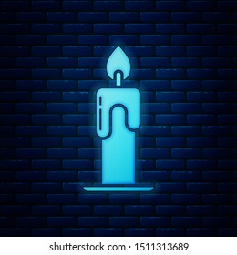 Glowing neon Burning candle icon isolated on brick wall background. Cylindrical aromatic candle stick with burning flame. Happy Halloween party. Vector Illustration Glowing neon Burning candle icon isolated on brick wall background. Cylindrical aromatic candle stick with burning flame. Happy Halloween party. Vector Illustration