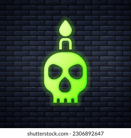 Glowing neon Burning candle on a skull icon isolated on brick wall background. Day of dead.  Vector