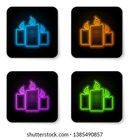 Glowing neon Burning candles icon isolated on white background. Old fashioned lit candles. Cylindrical aromatic candle sticks with burning flames. Black square button. Vector Illustration
