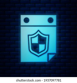 Glowing neon Calendar with shield icon isolated on brick wall background. Insurance concept. Guard sign. Security, safety, protection, privacy concept.  Vector