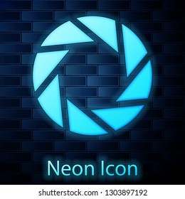Glowing neon Camera shutter icon isolated on brick wall background. Vector Illustration