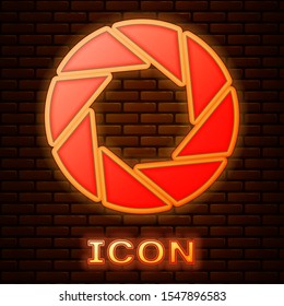 Glowing neon Camera shutter icon isolated on brick wall background.  Vector Illustration