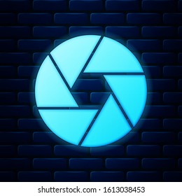 Glowing neon Camera shutter icon isolated on brick wall background.  Vector Illustration