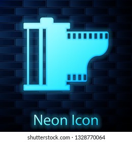 Glowing neon Camera vintage film roll cartridge icon isolated on brick wall background. Film reel icon. 35mm film canister. Filmstrip photographer equipment. Vector Illustration