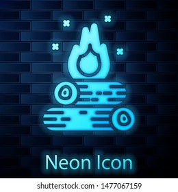 Glowing neon Campfire icon isolated on brick wall background. Burning bonfire with wood.  Vector Illustration