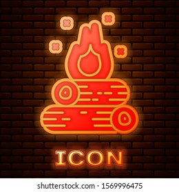 Glowing neon Campfire icon isolated on brick wall background. Burning bonfire with wood.  Vector Illustration