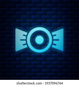 Glowing neon Candy icon isolated on brick wall background.  Vector