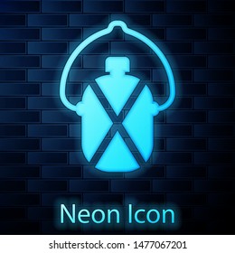 Glowing neon Canteen water bottle icon isolated on brick wall background. Tourist flask icon. Jar of water use in the campaign.  Vector Illustration
