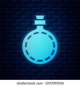 Glowing neon Canteen water bottle icon isolated on brick wall background. Tourist flask icon. Jar of water use in the campaign.  Vector