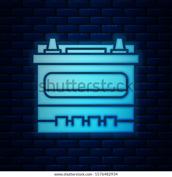 Glowing neon Car battery
icon isolated on brick wall background. Accumulator battery energy
power and electricity accumulator battery.  Vector
Illustration