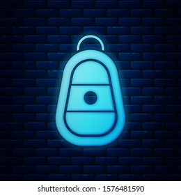 Glowing neon Car key with remote icon isolated on brick wall background. Car key and alarm system.  Vector Illustration