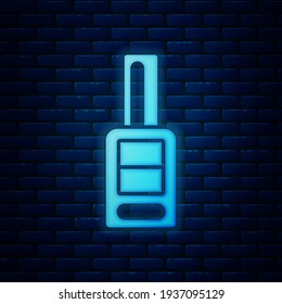 Glowing neon Car key with remote icon isolated on brick wall background. Car key and alarm system.  Vector