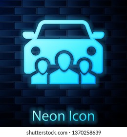 Glowing neon Car sharing with group of people icon isolated on brick wall background. Carsharing sign. Transport renting service concept. Vector Illustration