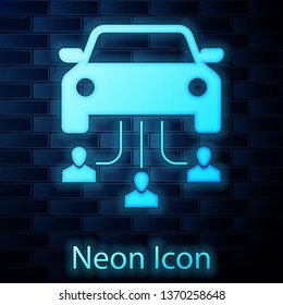 Glowing neon Car sharing with group of people icon isolated on brick wall background. Carsharing sign. Transport renting service concept. Vector Illustration