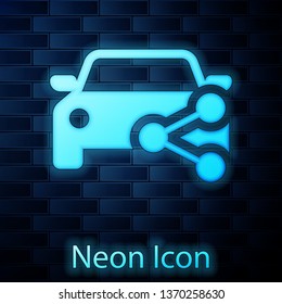 Glowing neon Car sharing icon isolated on brick wall background. Carsharing sign. Transport renting service concept. Vector Illustration