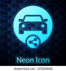 Glowing neon Car sharing icon isolated on brick wall background. Carsharing sign. Transport renting service concept. Vector Illustration