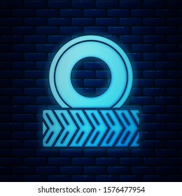 Glowing neon Car wheel icon isolated on brick wall background.  Vector Illustration