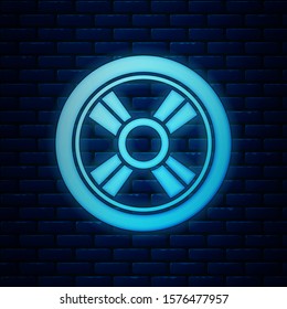 Glowing neon Car wheel icon isolated on brick wall background.  Vector Illustration